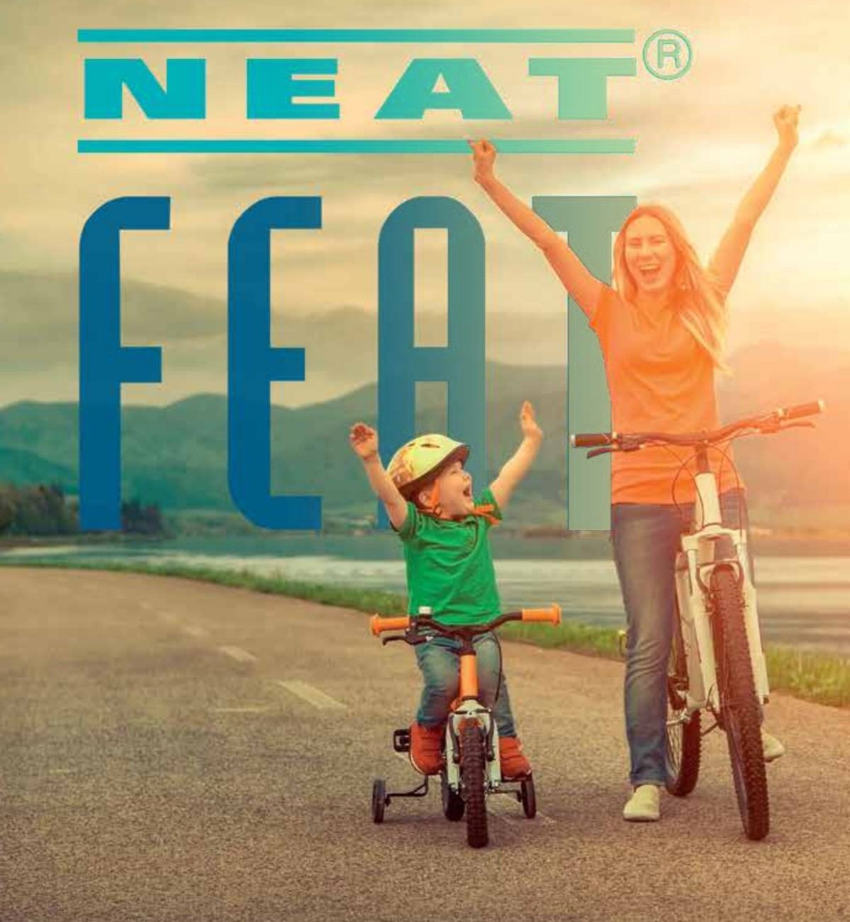 A mother and her young son celebrating on a bike ride together at sunset
